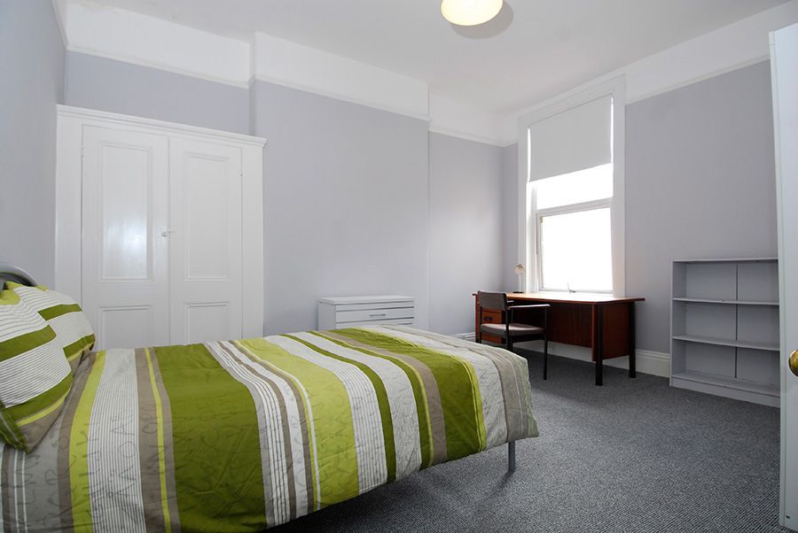 Classic double room with bed and open window view