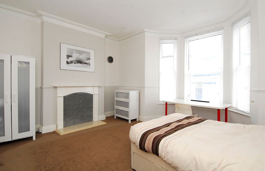 Classic double room having bed and open window view
