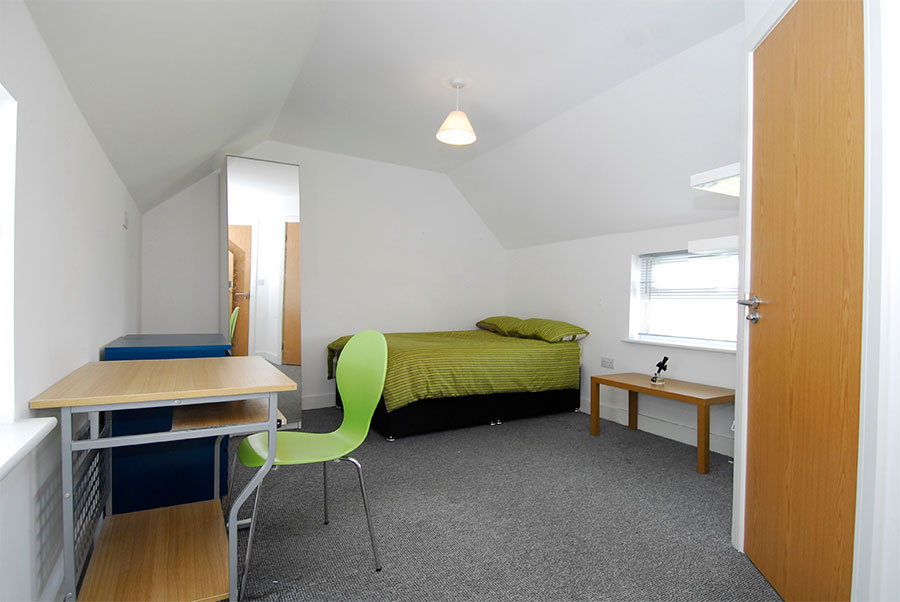 En-suite double room having bed and study table