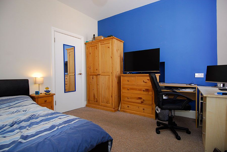 En-suite double room having bed, tv and computer table with chair