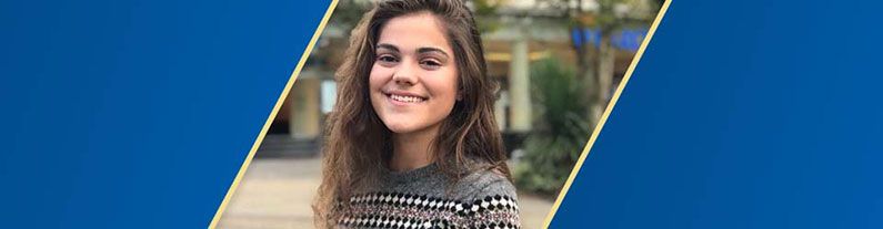 A female student smiling in front of camera