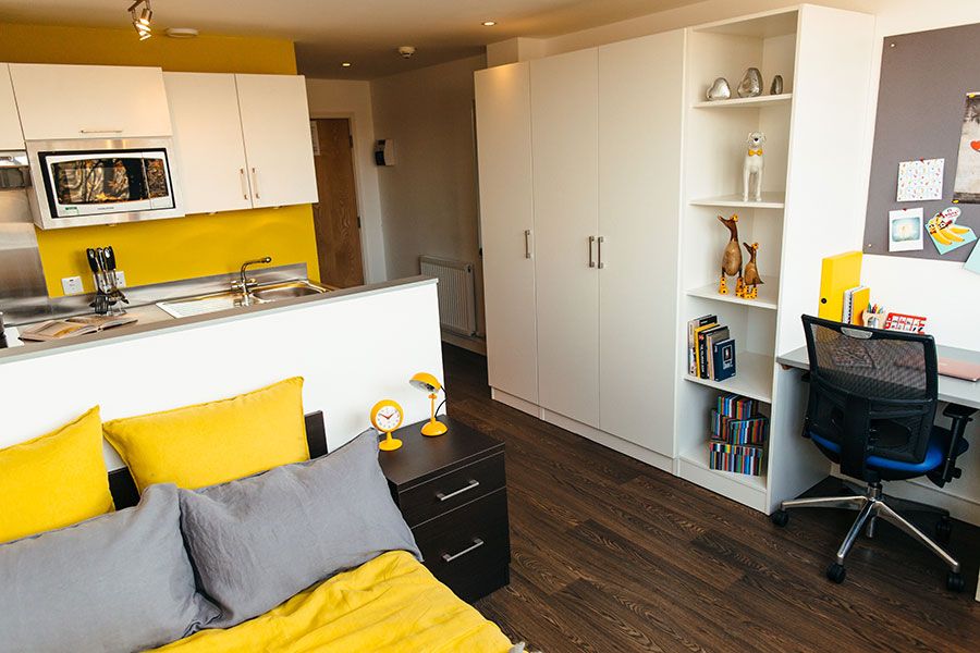 Luxury studio apartment room having bed, study table