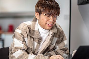 Male student working on laptop