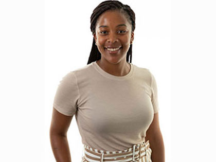 A female student smiling in front of camera