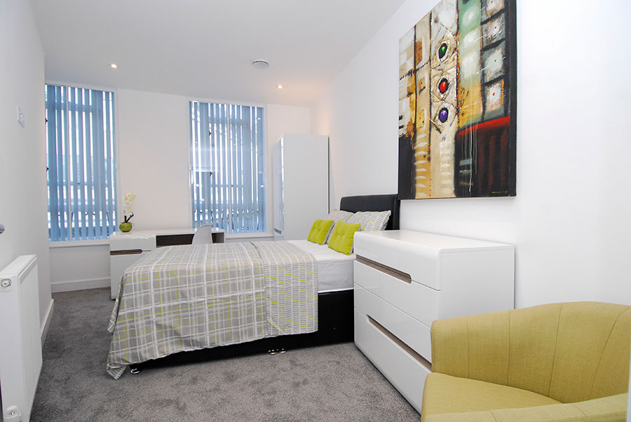 Premium en-suite double room having bed and two window