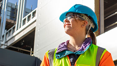 Female student on building site wearing PPE