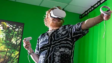 Male student using virtual reality headset