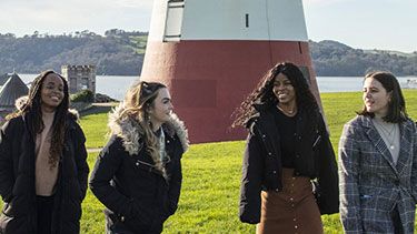 Students at Plymouth seafront Smeaton's tower
