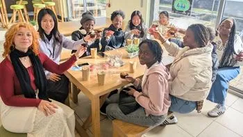Students celebrate with hot chocolate and cupcakes on campus.