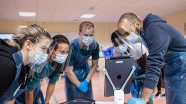 Healthcare professionals looking at the iPad screen